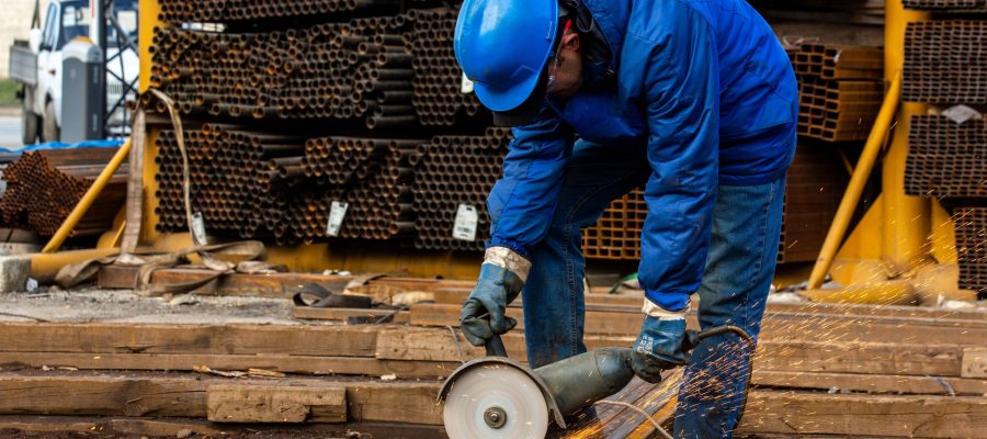 worker cuts iron with tool